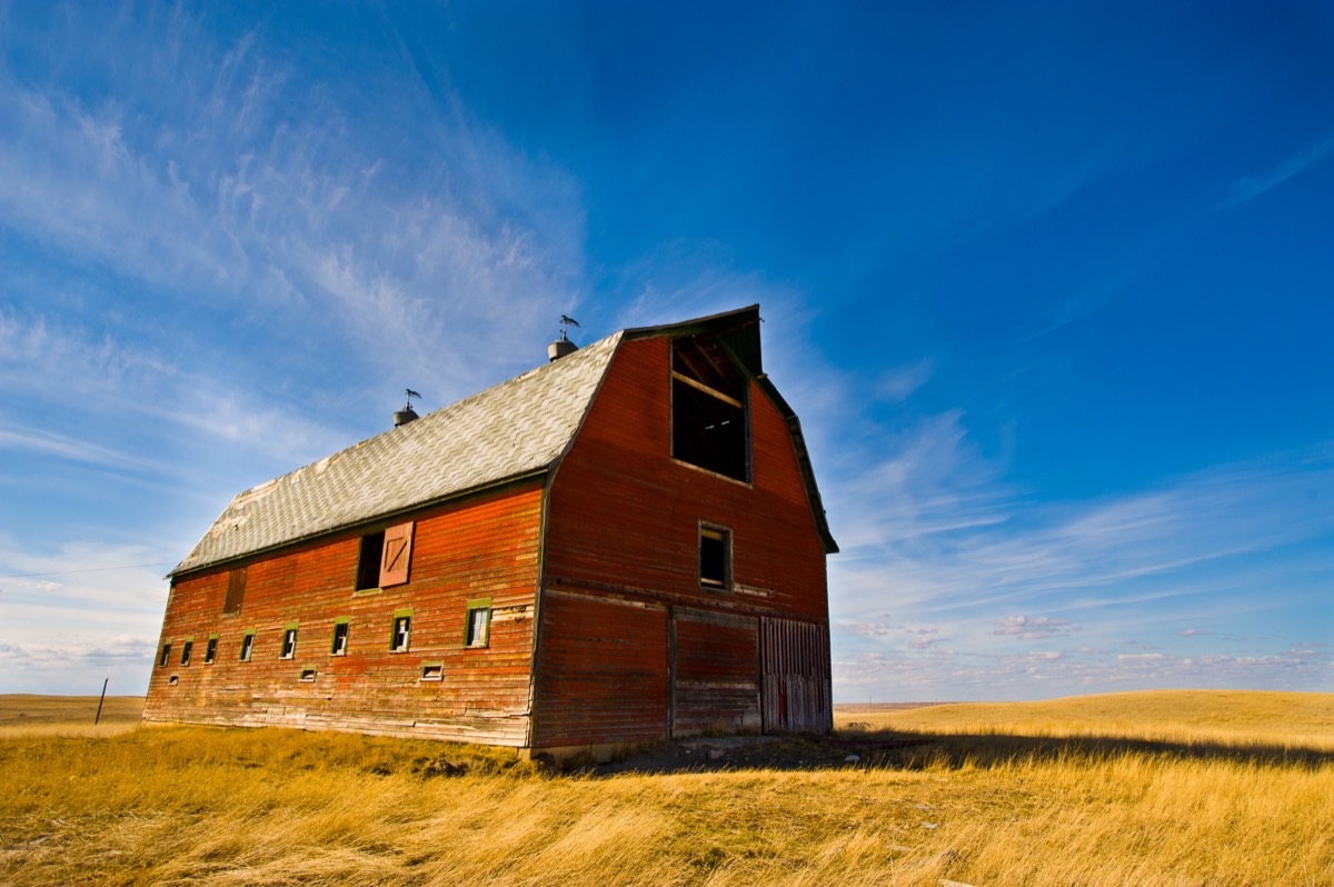 Old red barn under blue sky
